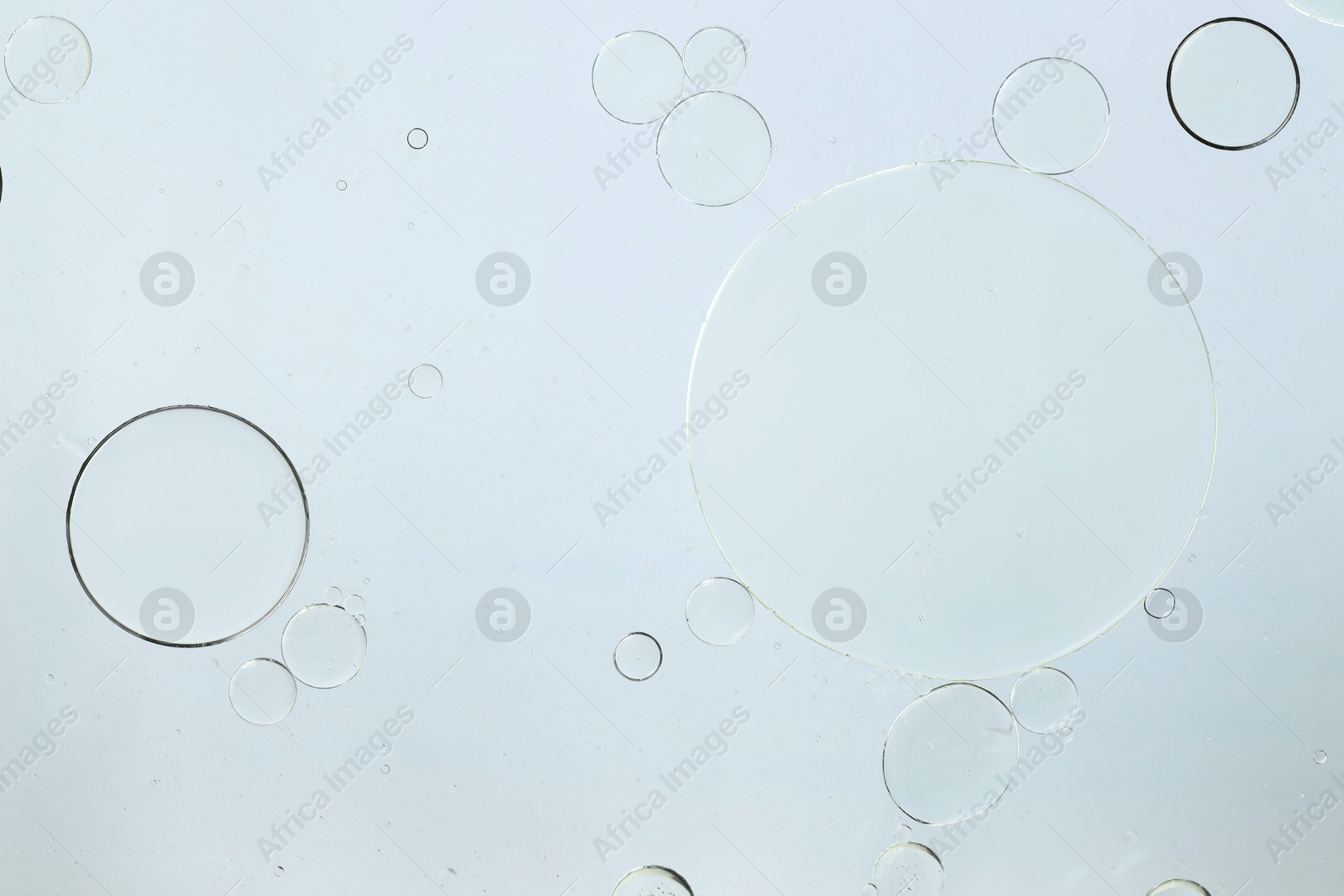 Photo of Sample of cosmetic oil on white background, macro view