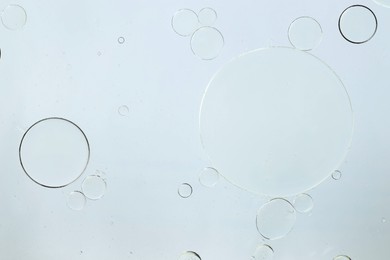 Photo of Sample of cosmetic oil on white background, macro view