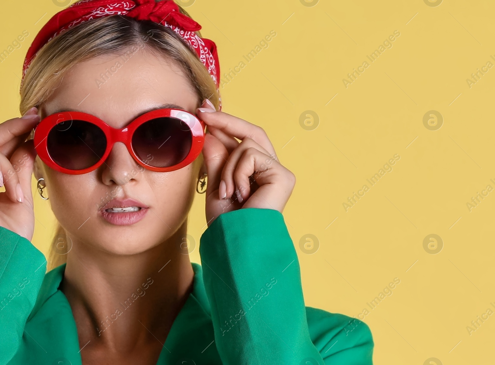 Photo of Beautiful woman in stylish green jacket on yellow background