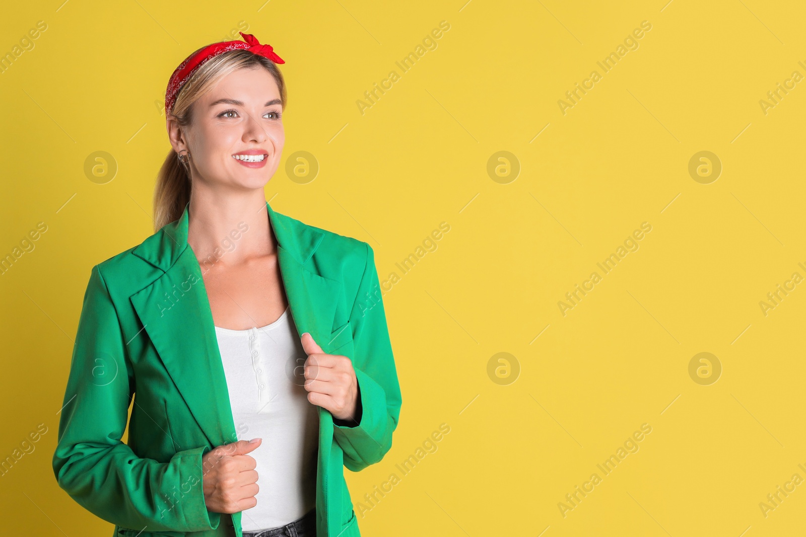 Photo of Beautiful woman in stylish green jacket on yellow background