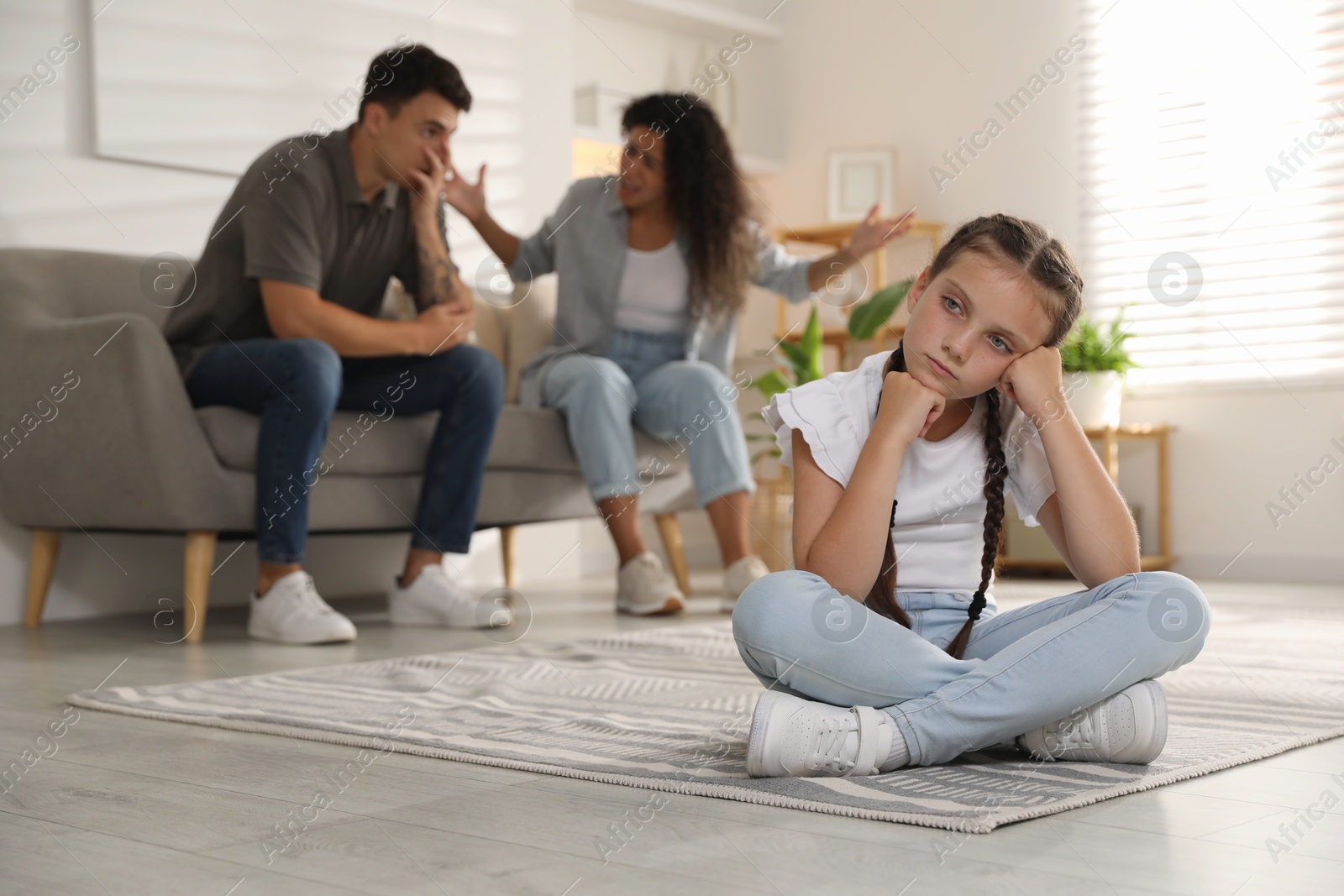 Photo of Divorce concept. Angry couple arguing at home, focus on their sad daughter