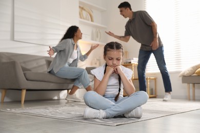 Photo of Divorce concept. Angry couple arguing at home, focus on their sad daughter