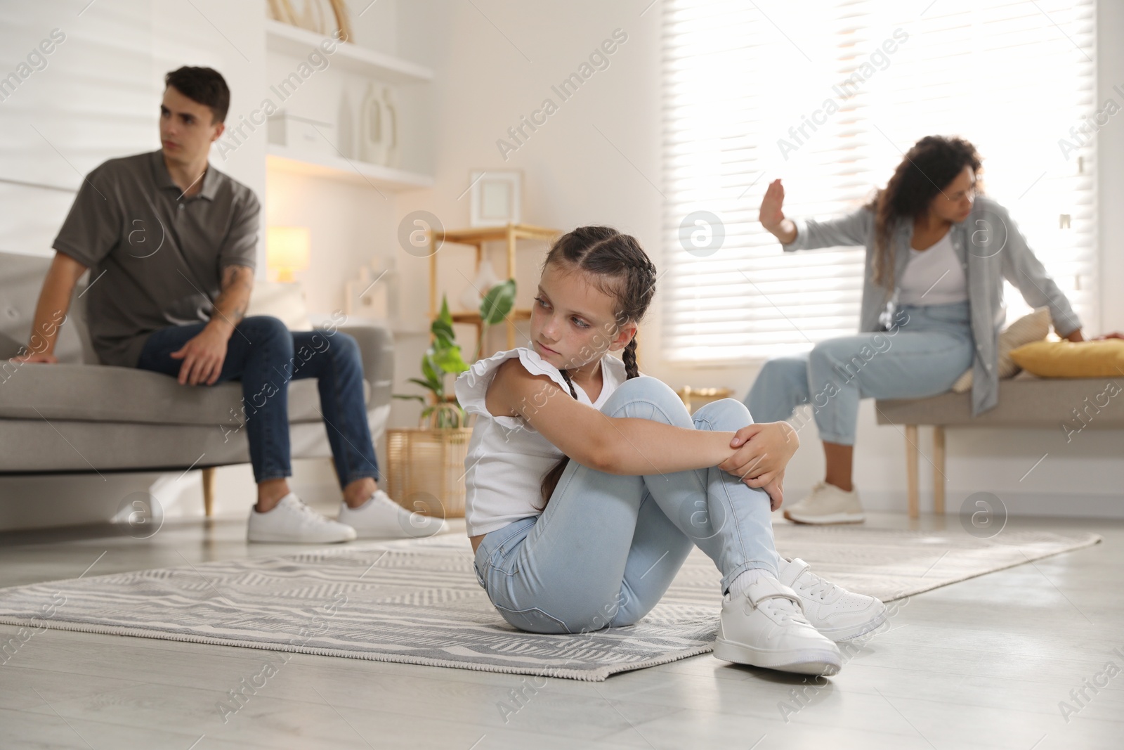 Photo of Divorce concept. Angry couple arguing at home, focus on their sad daughter