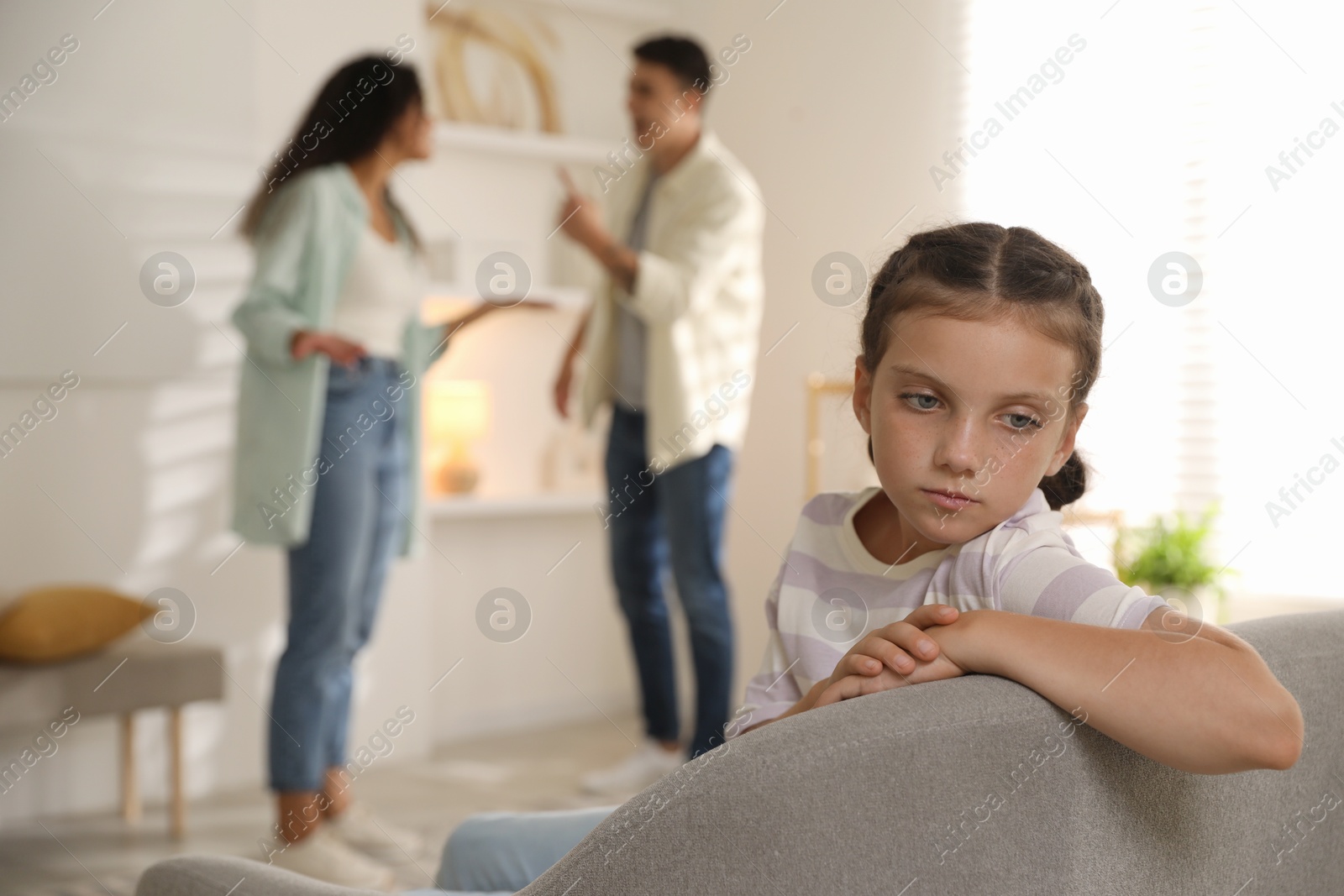 Photo of Divorce concept. Angry couple arguing at home, focus on their sad daughter