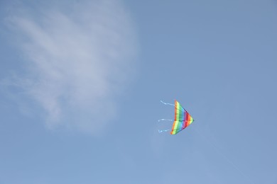 One colorful kite flying in blue sky. Space for text