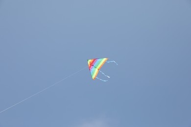 One colorful kite flying in blue sky