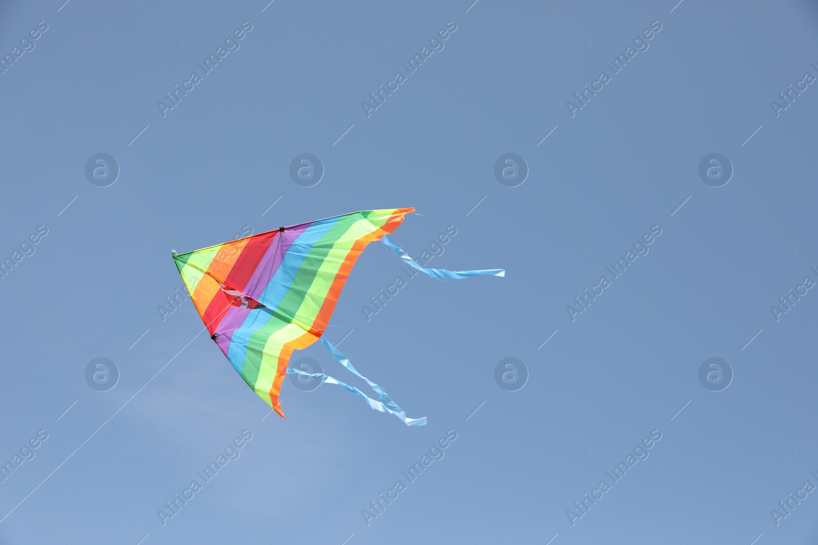 Photo of One colorful kite flying in blue sky