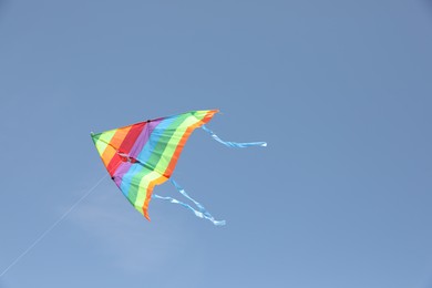 Photo of One colorful kite flying in blue sky