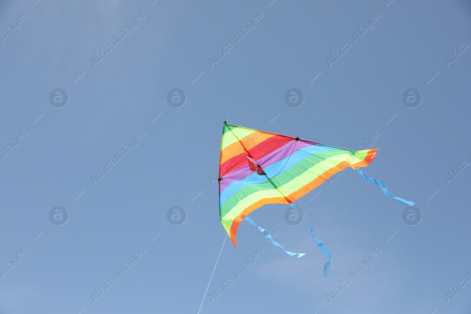 Photo of One colorful kite flying in blue sky