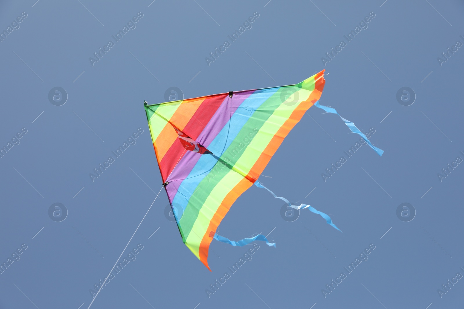 Photo of One colorful kite flying in blue sky