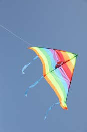 Photo of One colorful kite flying in blue sky