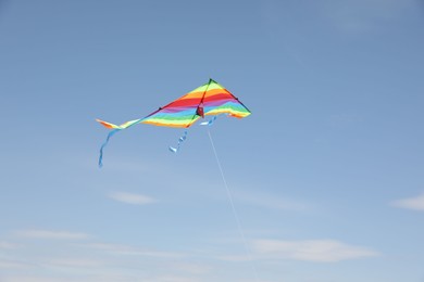 One colorful kite flying in blue sky