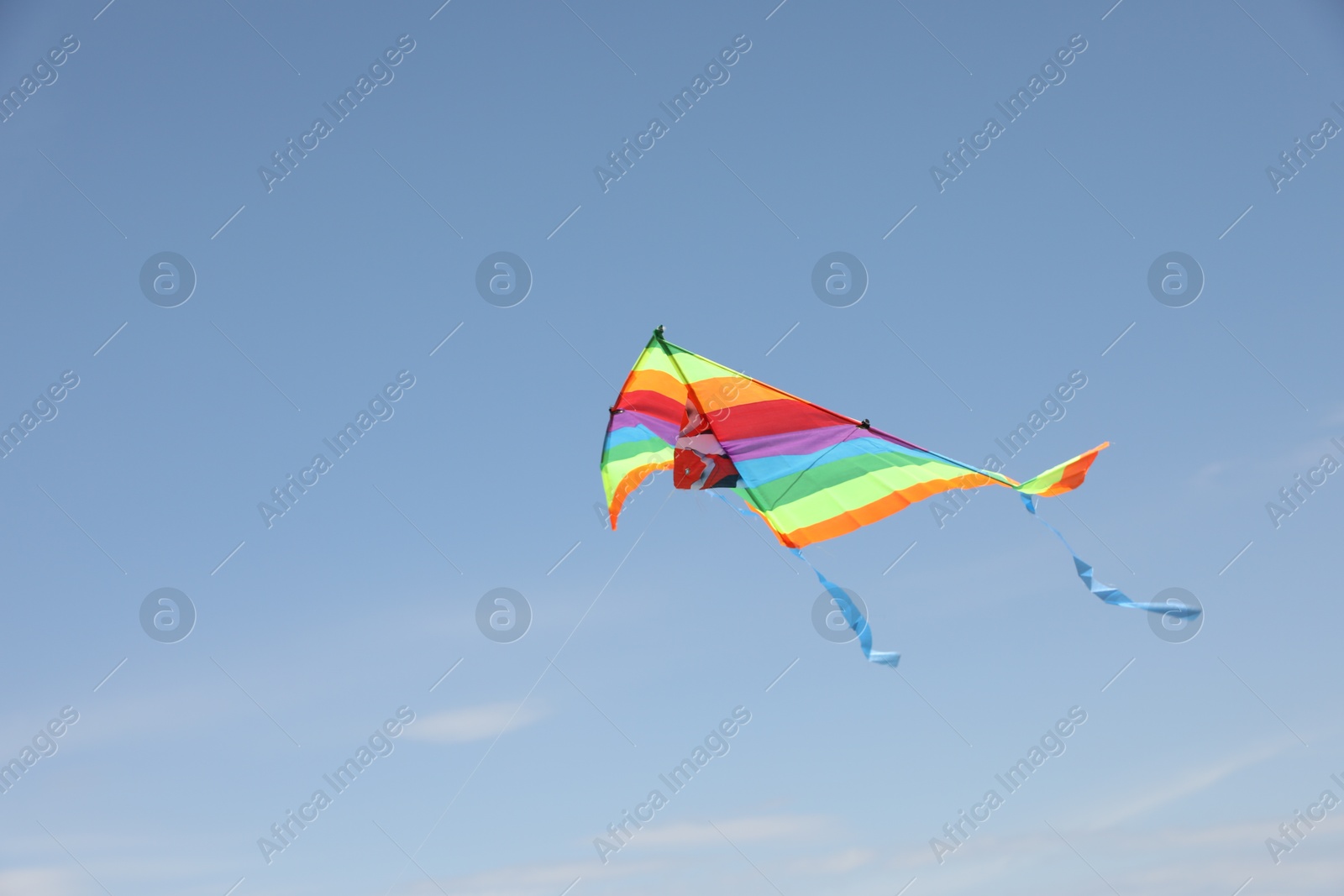 Photo of One colorful kite flying in blue sky