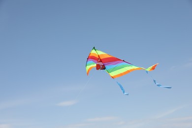 One colorful kite flying in blue sky