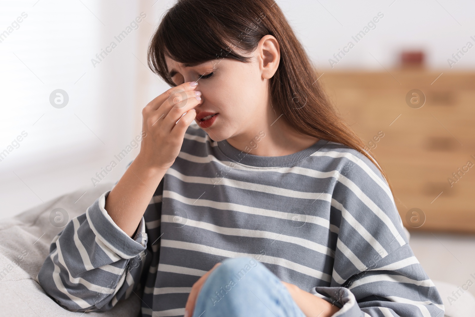 Photo of Tired woman suffering from sinusitis at home