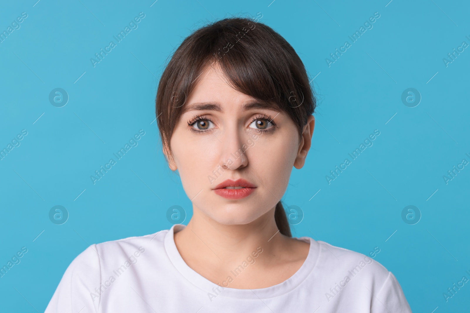 Photo of Portrait of frustrated woman on light blue background