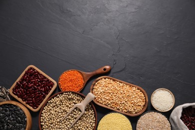 Photo of Different types of cereals, seeds and legumes on grey textured table, flat lay. Space for text