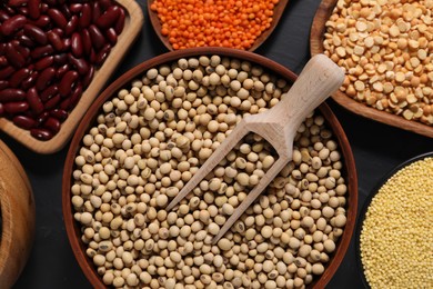 Photo of Different types of cereals and legumes on grey table, flat lay