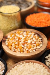 Different types of cereals and legumes on table, closeup