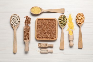 Different types of legumes, cereals and seeds on white wooden table, flat lay