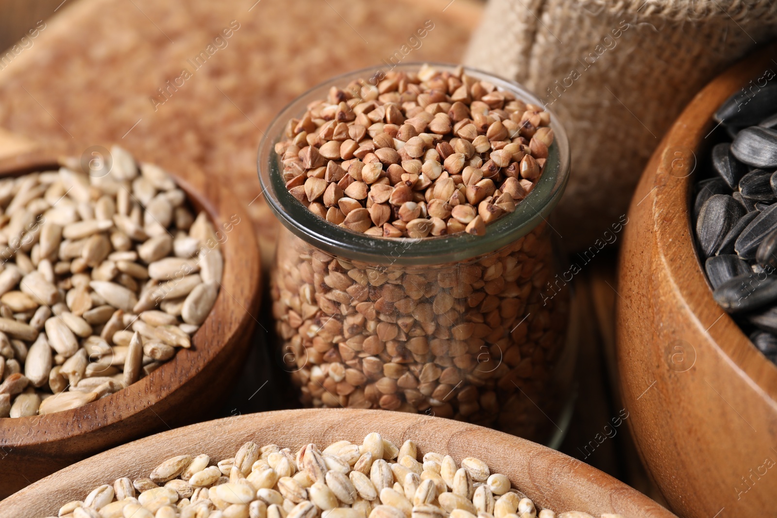 Photo of Different types of cereals and seeds on table, closeup