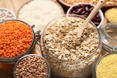 Photo of Different types of cereals and legumes on table, closeup