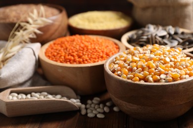 Photo of Different types of cereals, seeds and legumes on table, closeup