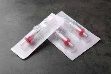 Many disposable cartridge systems for permanent makeup on grey background