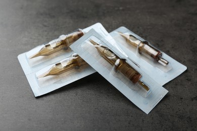 Many disposable cartridge systems for permanent makeup on grey background