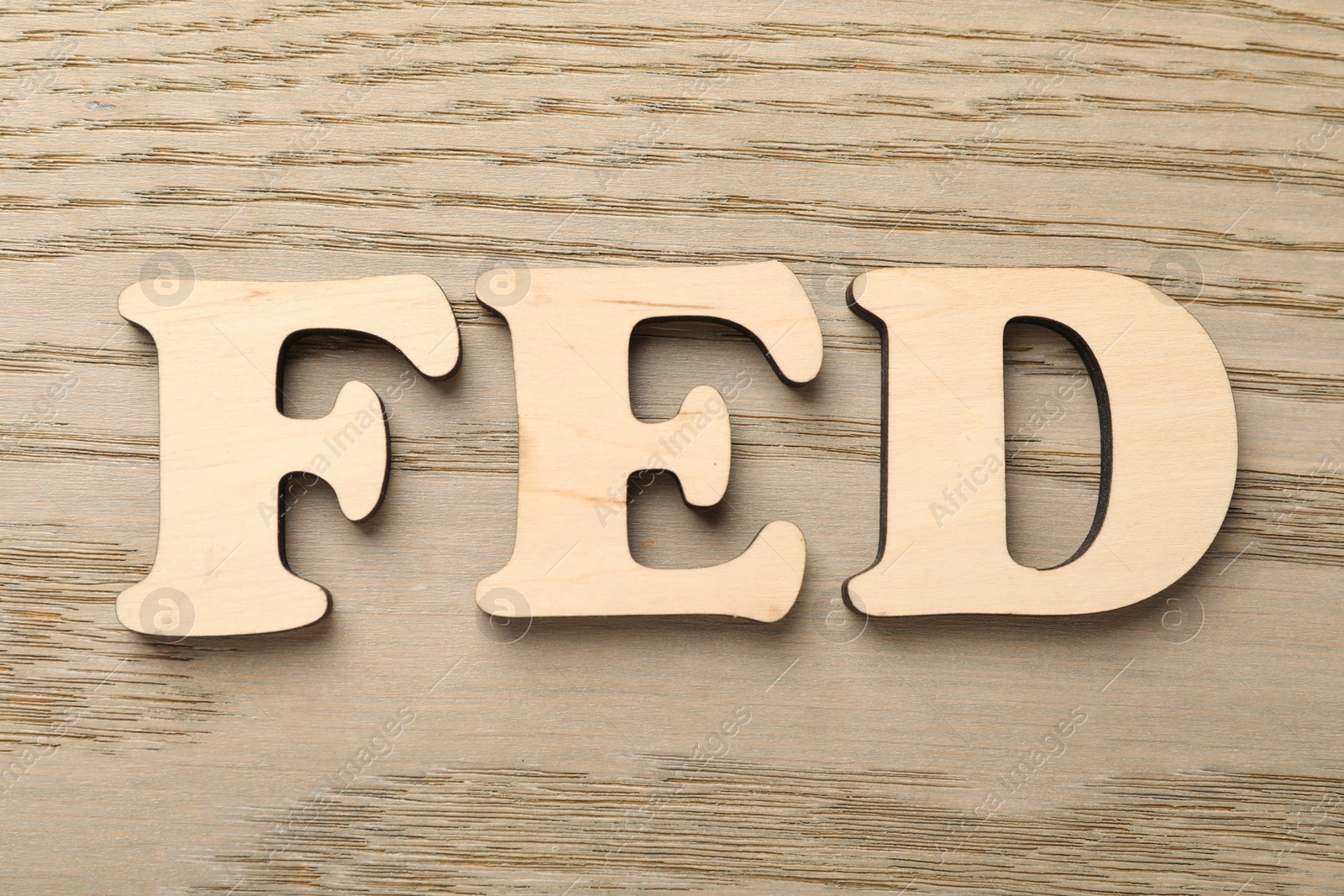 Photo of Wooden letters Fed (Federal Reserve System) on table, top view