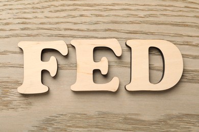 Photo of Wooden letters Fed (Federal Reserve System) on table, top view