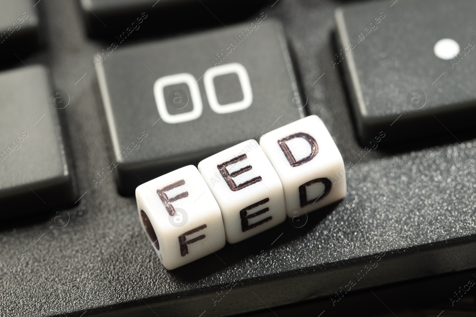 Photo of Cubes with letters Fed (Federal Reserve System) on keyboard, closeup