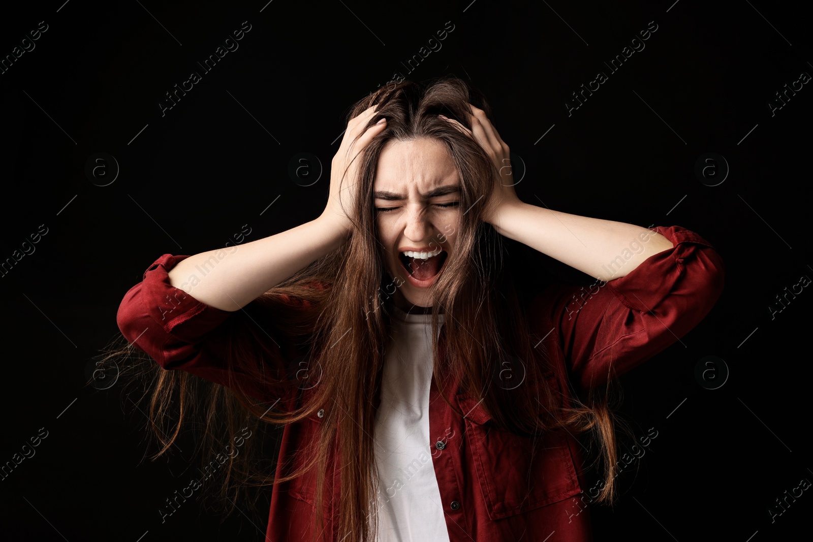 Photo of Portrait of scared woman on black background