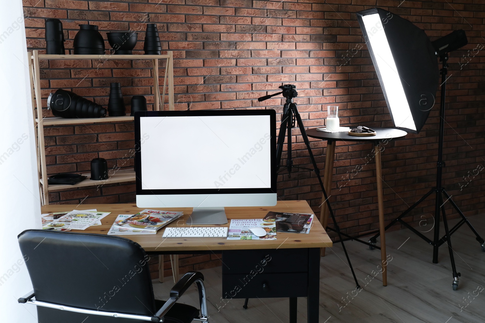 Photo of Shooting food in photo studio with professional equipment, focus on computer