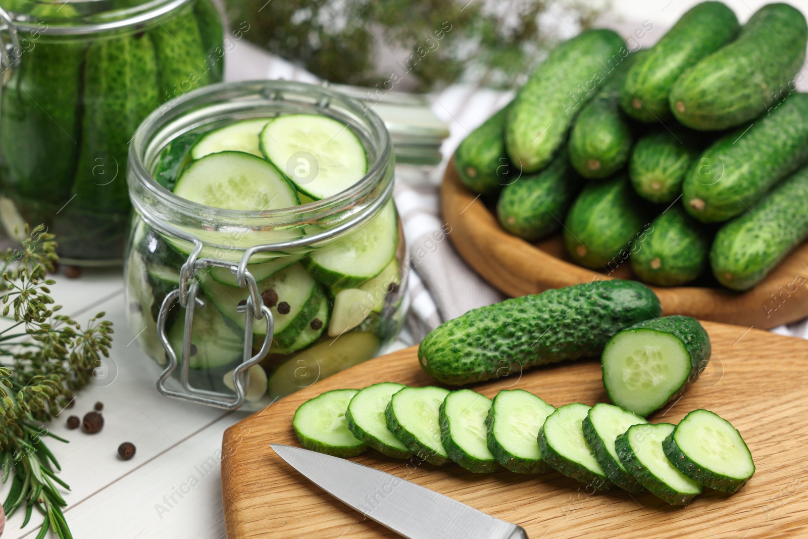 Photo of Fresh cucumbers on light table, closeup. Preparation for pickling