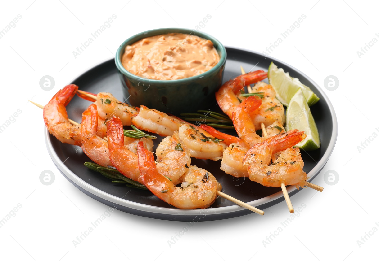 Photo of Skewers with delicious grilled shrimps, lime and sauce isolated on white