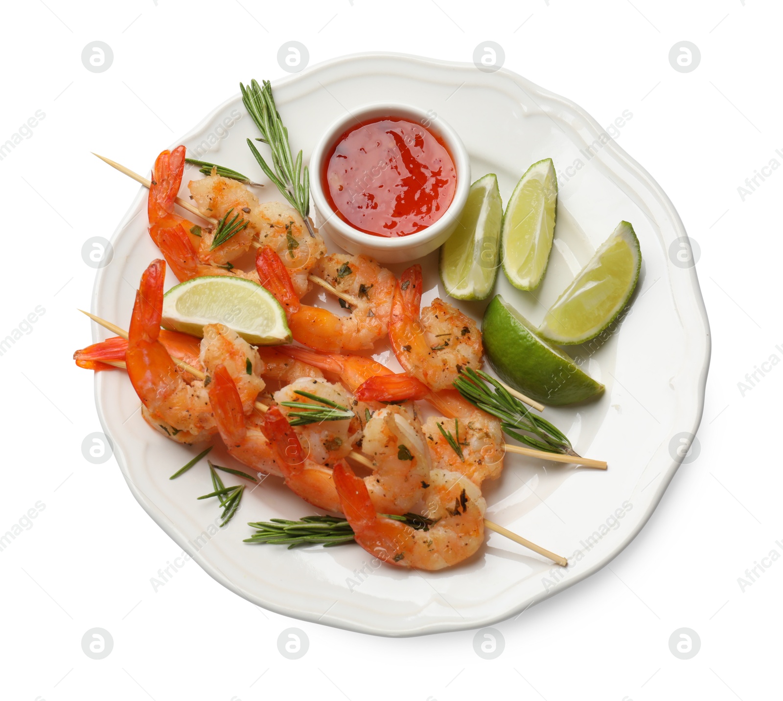 Photo of Skewers with delicious grilled shrimps, lime and sauce isolated on white, top view