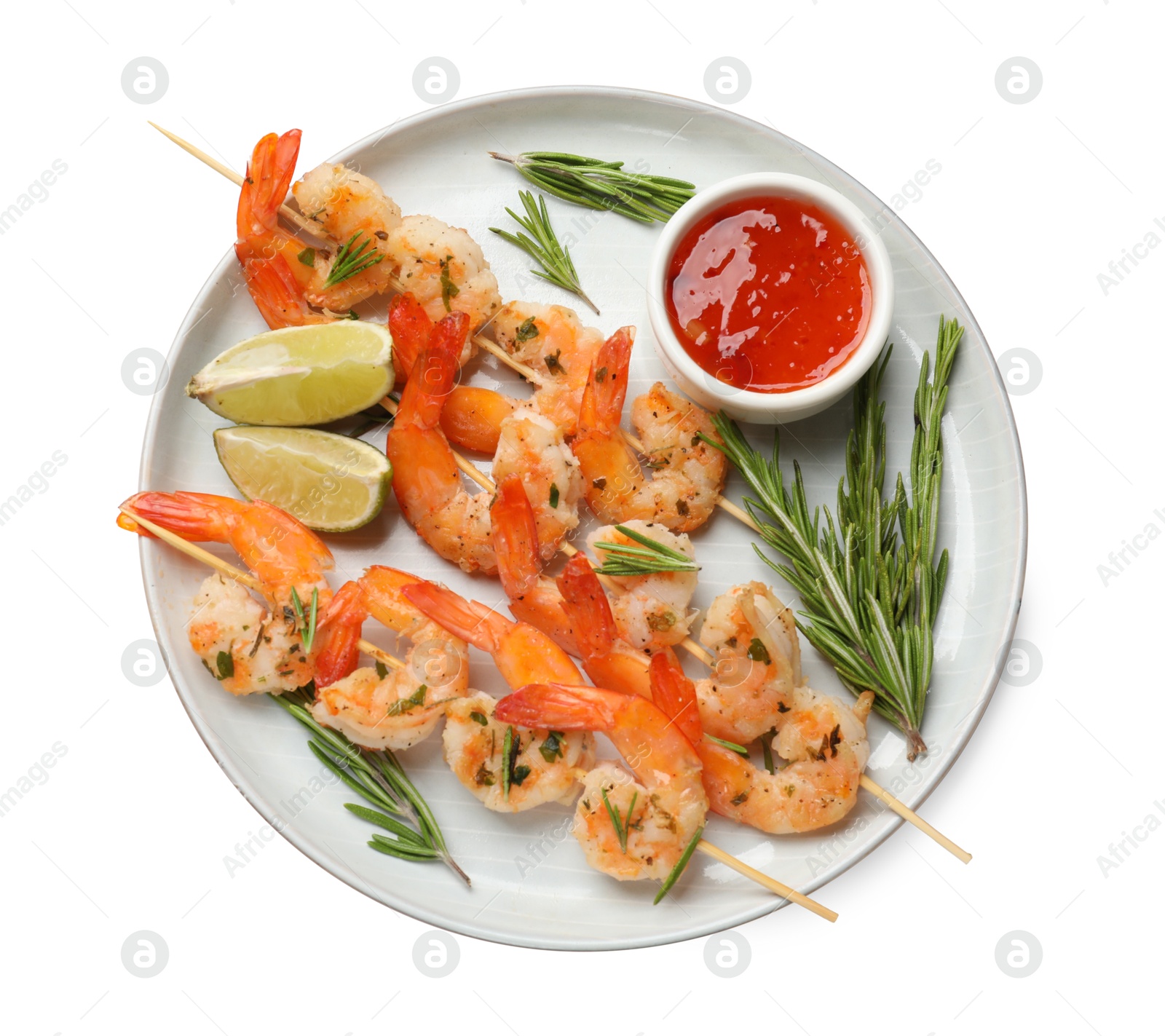 Photo of Skewers with delicious grilled shrimps, lime and sauce isolated on white, top view