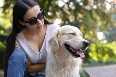 Photo of Portrait of owner with cute Golden Retriever dog outdoors