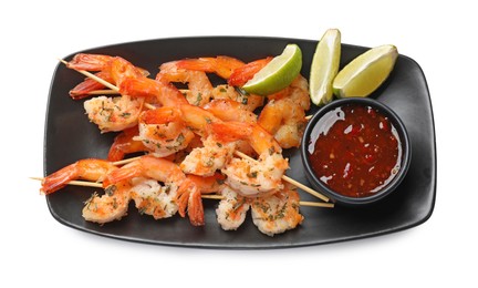 Photo of Delicious grilled shrimp skewers with sauce and lime isolated on white, top view