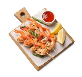 Photo of Delicious grilled shrimp skewers with sauce and lime isolated on white, top view