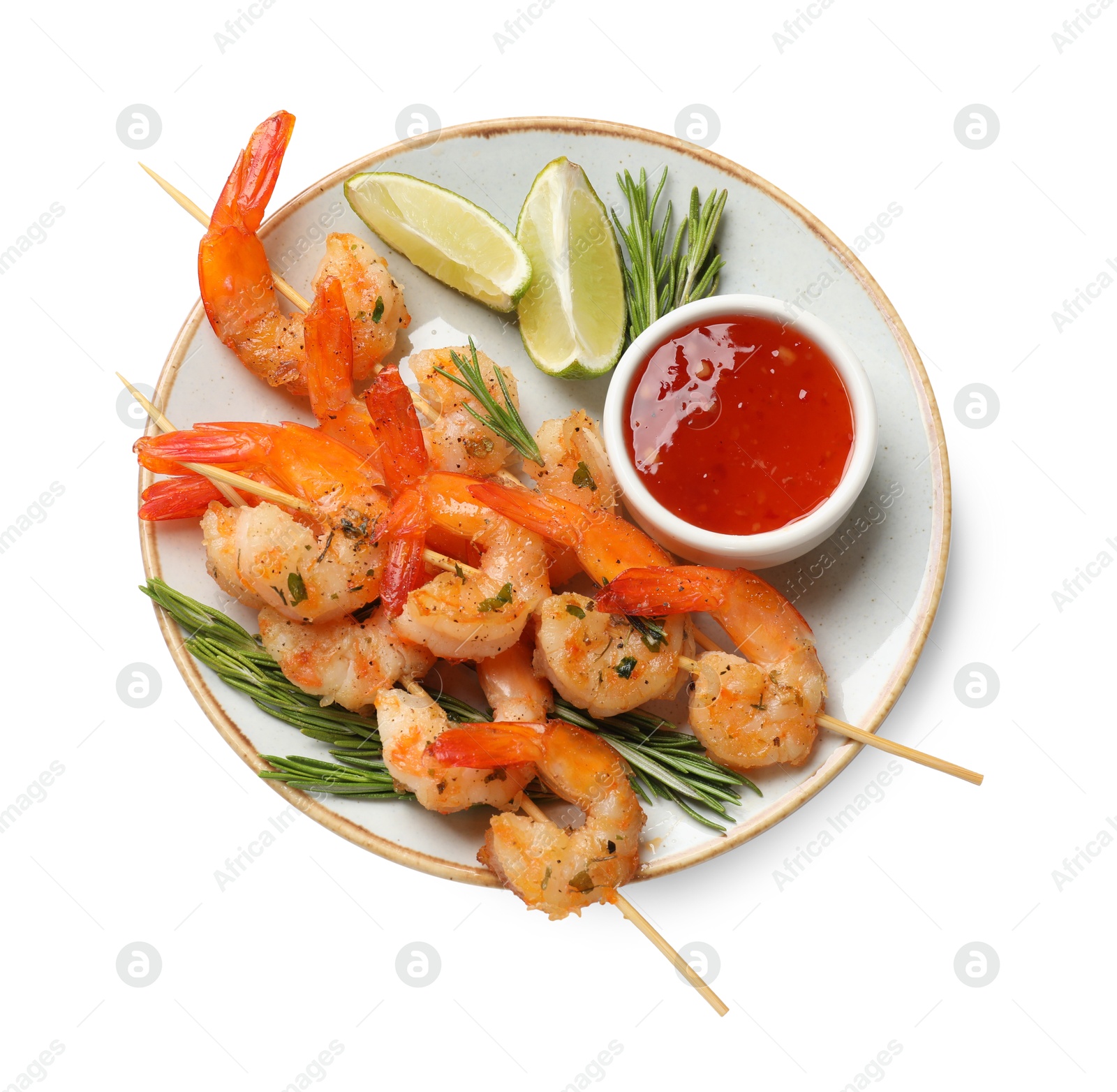 Photo of Delicious grilled shrimp skewers with sauce and lime isolated on white, top view