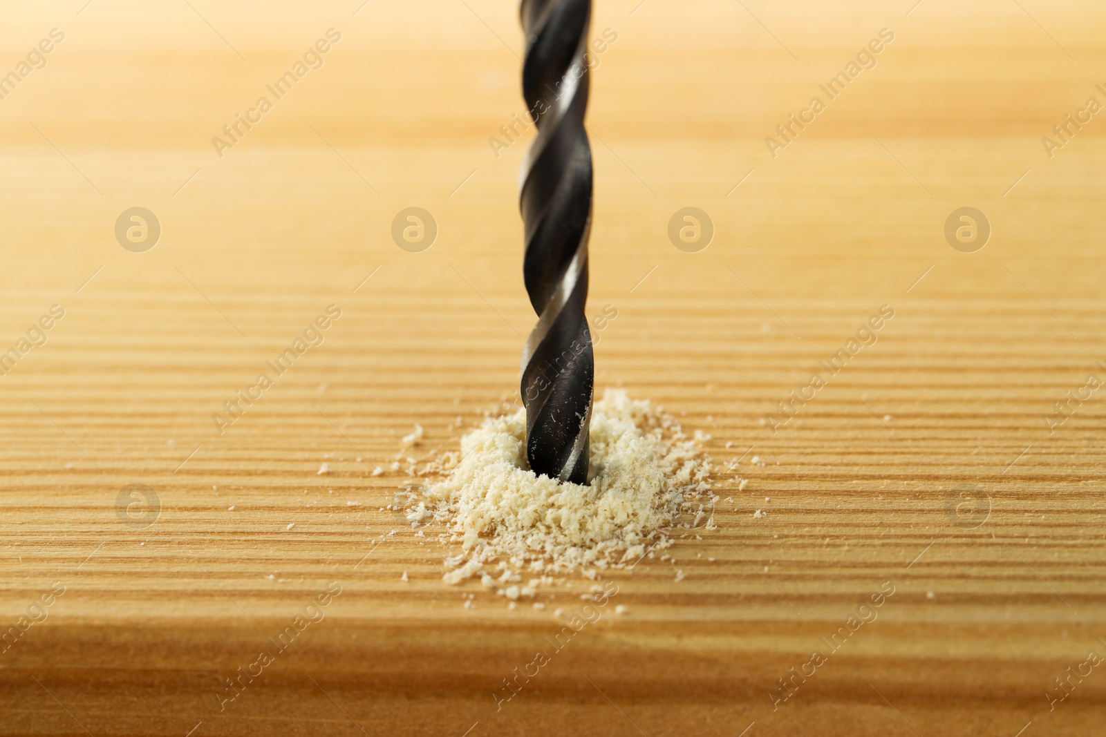 Photo of Drilling hole in wooden plank, closeup view