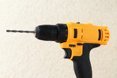 Photo of One cordless electric drill against blurred background