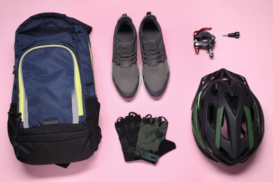 Flat lay composition with cycling accessories on pink background