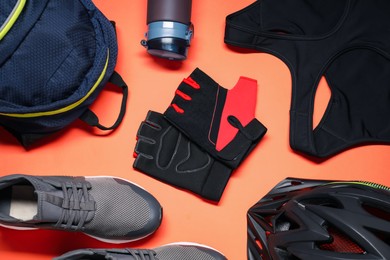 Photo of Flat lay composition with cycling accessories on coral background