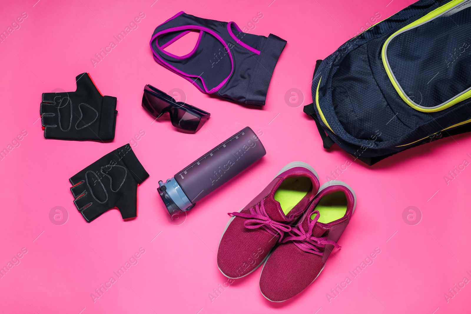 Photo of Flat lay composition with cycling accessories on pink background