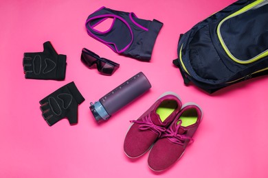 Flat lay composition with cycling accessories on pink background