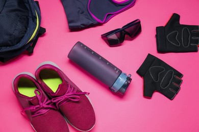 Flat lay composition with cycling accessories on pink background