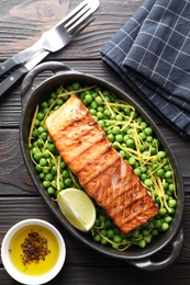 Photo of Delicious grilled salmon fillet in baking dish served on wooden table, flat lay